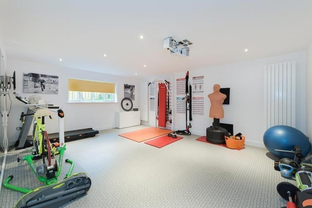 This reception room on the ground floor of the property has been turned into a terrific gym. It could even be used as a cinema room.