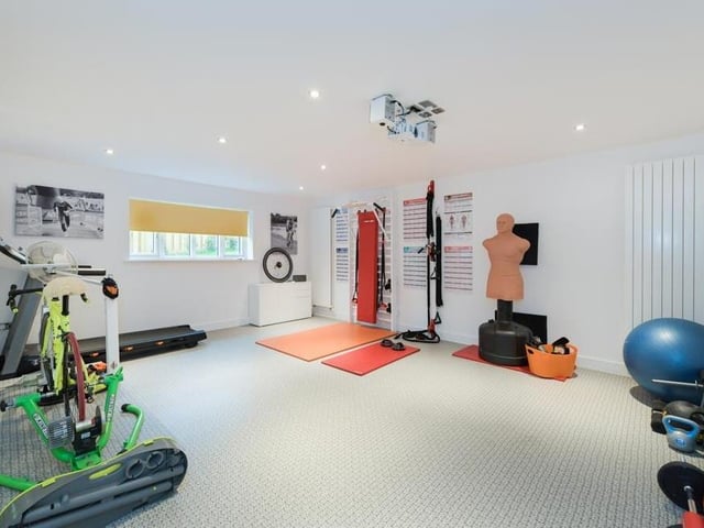 This reception room on the ground floor of the property has been turned into a terrific gym. It could even be used as a cinema room.