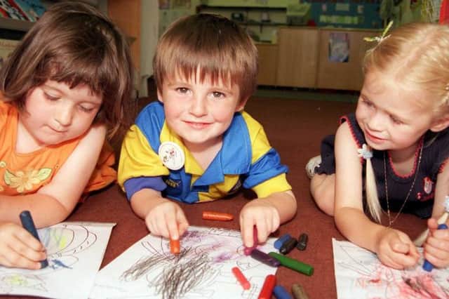 Colouring fun at Doncaster central library, 1999. Charlotte Hicks, aged three from Kirk Sandall with friends Joe and Olivia.