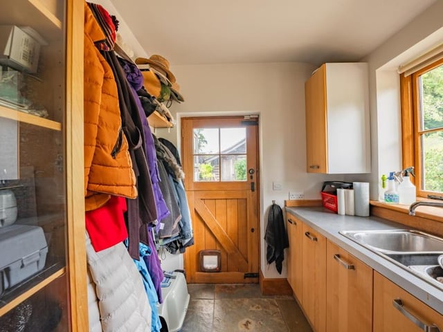 A corner of the ground floor is devoted to this useful boot room, which could also be used as a laundry room.The door leads out to the garden.