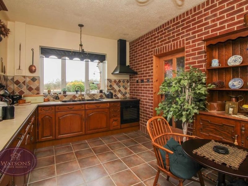 Moving on now to the breakfast kitchen, which has a rustic charm about it. The room features a range of matching wall and base units, plus work surfaces incorporating a sink and drainer unit.There is room for a breakfast table on the tiled floor.