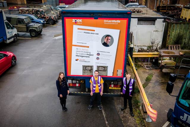 James Pemblington who had not worked for around eight months, who now has a new job thanks to his giant CV being advertised on the back of a lorry -  Pictured with Edward Hollands - DrivenMedia & Hannah Scragg from Zoek.