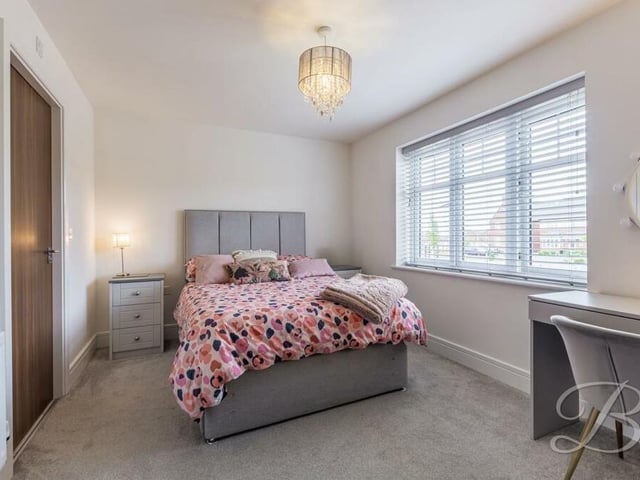 This bright and spacious bedroom is the ideal, peaceful retreat. It has a carpeted floor and built-in wardrobes.