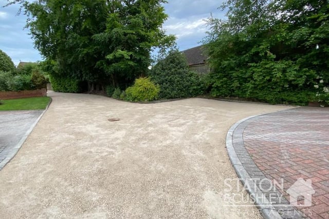 A good-sized granite-chip driveway at the front of the house provides off-street parking space for eight cars and leads to an integral double garage.