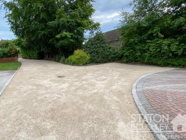 A good-sized granite-chip driveway at the front of the house provides off-street parking space for eight cars and leads to an integral double garage.