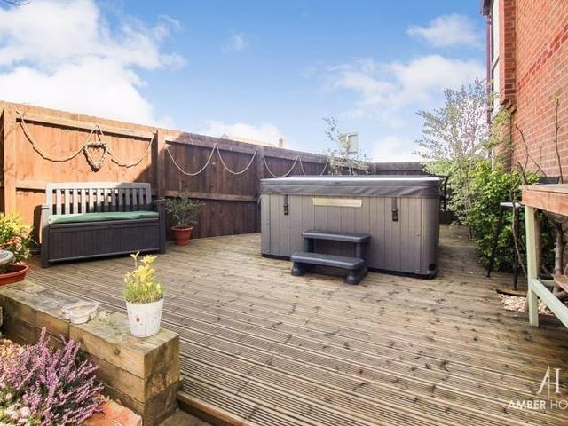 Our last photo shows a decked area at the back of the Erica Drive house. The garden as a whole has so much going for it.