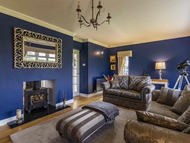 Like the sitting room, the lounge boasts a feature fireplace with a traditional log-burner.
