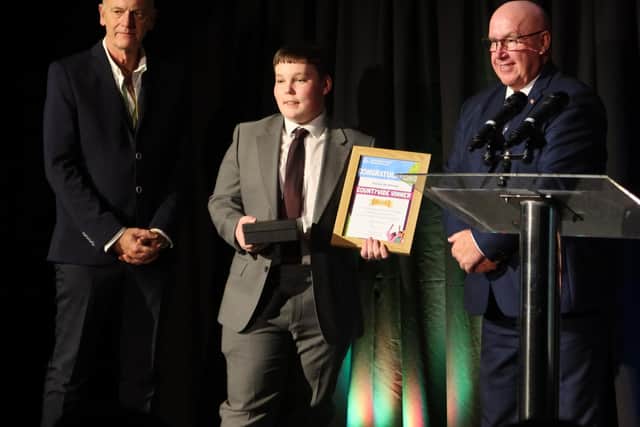 Archie Matthews receiving his award council leader Councillor Mick Barton, and nominator Paul.