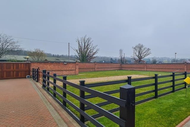 The grounds to the property are accessed only via an electrically operated gate, while the perimeter is walled.