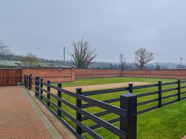 The grounds to the property are accessed only via an electrically operated gate, while the perimeter is walled.