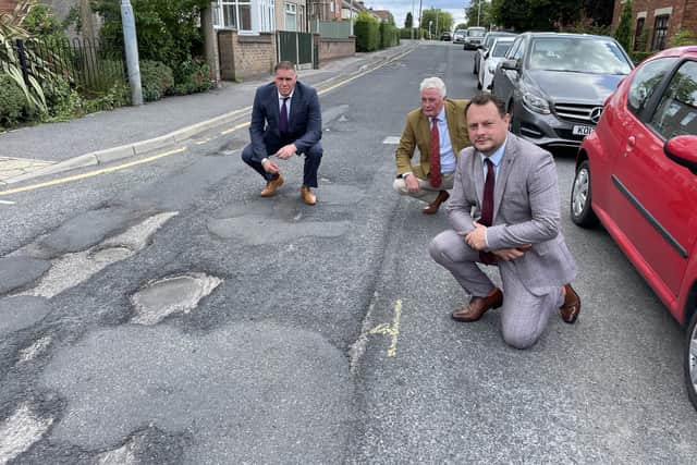 Couns Andy Gascoyne, Arnie Harkin and Jason Zadrozny-Bland examine another Ashfield pothole
