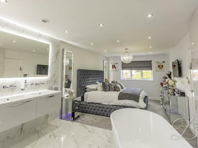 The master bedroom from a different angle. It boasts a carpeted floor, underfloor heating, downlights and a window facing the back of the £595,000-plus property.