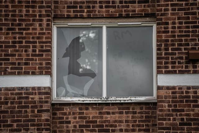 The shattered window which the female victim is thought to have fallen through. Credit: Tom Maddick