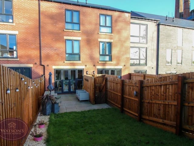 The final photo in our gallery is a shot from the back of the Brewhouse Mews house. Timber fencing to the perimeter of the garden offers a good level of privacy.