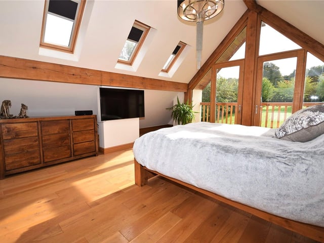 A vaulted ceiling, which adds to the sense of space, and a covered balcony, which provides panoramic views, are what makes the principal bedroom something special.