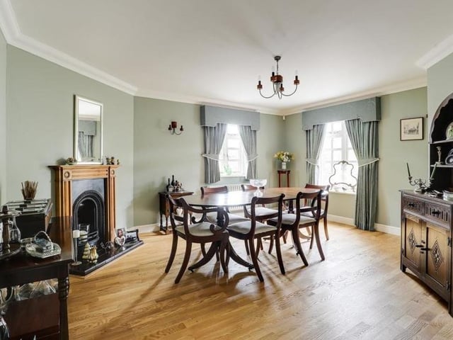 Let's launch our tour of the Longdale Lane property in this majestic dining room.  A feature fireplace with decorative surround stands out, but the room also benefits from dual-aspect, wood-framed, double-glazed windows, engineered wood flooring and coving to the ceiling.