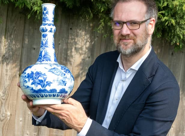 Charles Hanson with a Chinese vase.
