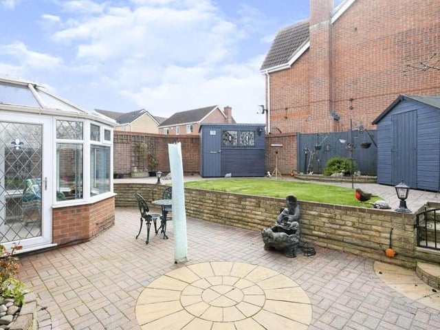 Stepping back outside now, this is the lovely rear garden. Ingeniously designed, it sits on two levels, with access to the conservatory too.