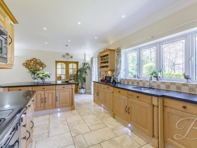The kitchen from a different angle. Integrated appliances abound, including a Rangemaster cooker, fridge freezer, dishwasher and Neff microwave. The room also benefits from underfloor heating, downlights and a double glazed window to the back of the house.There is plenty of space too for a dining table.
