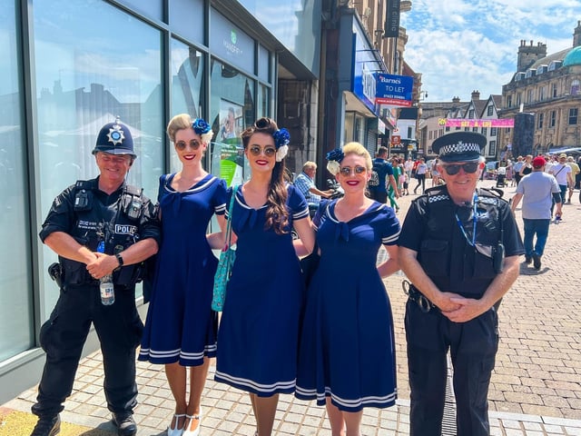 Police officers pose for a photo with the Bluebird Belles.