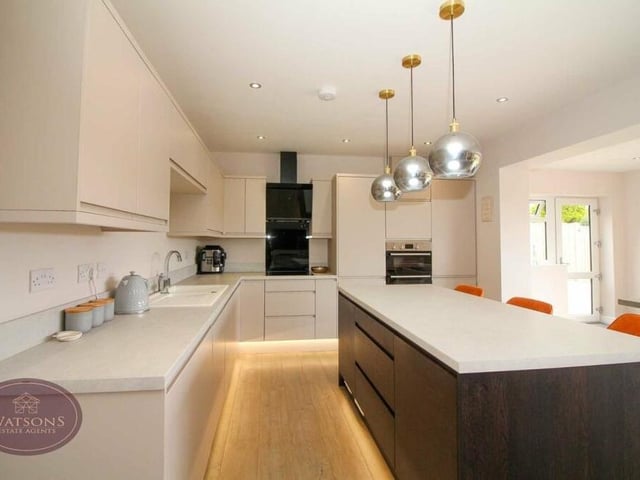 Let's take a closer look at the kitchen, which is fitted with contemporary, matching wall and base units, and work surfaces incorporating an inset one-and-a-half bowl country-style sink and drainer unit. Feature lighting adds style to the room.