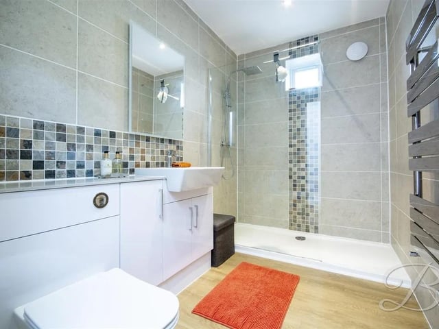 The principal bedroom boasts a stylish en suite shower room
