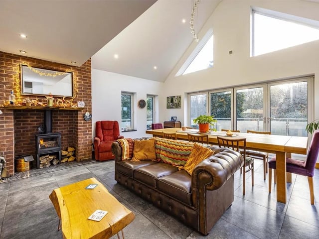 The open plan kitchen, dining, living area is flooded with natural light and offers seamless views across the grounds.