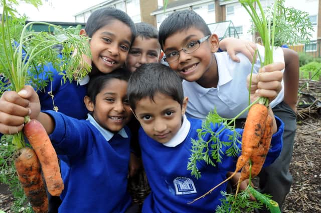 These pupils were enjoying the new community garden in 2013. Can you spot someone you know?