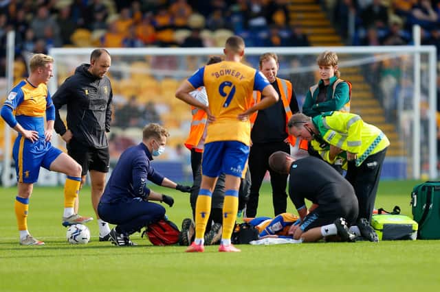 Mansfield Town midfielder George Maris receives treatment. Pihoto by Chris Holloway/The Bigger Picture.media