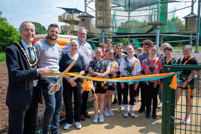 Nottinghamshire County Council chairman, Councillor Richard Butler, cuts the ribbon at Adventures.
