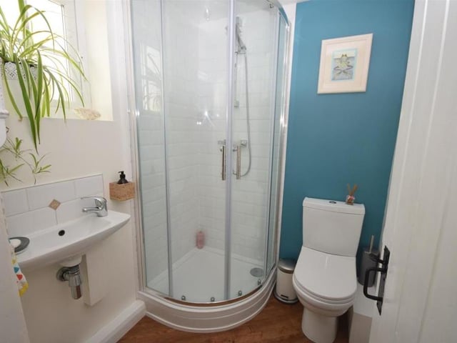 This shower room is a useful addition to the ground floor. It comprises a modern suite with shower cubicle, wash hand basin with mixer tap, and low-flush WC. There is also a chrome heated towel-rail, and the room is tastefully decorated, with tiled splashbacks and contemporary Karndean flooring.