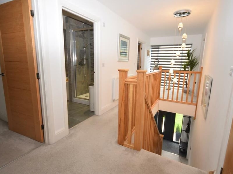 At the top of the stairs, you are greeted by this galleried landing, with a picture window at the front that floods the space with natural light. There is also a useful walk-in storage cupboard.