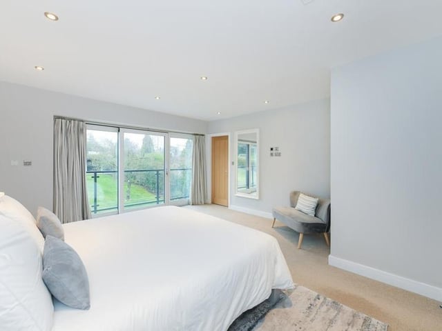 The main bedroom sits on the second floor. It features a balcony, overlooking the back garden, an en suite and a separate dressing room.,