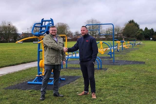 Cllr Craig Whitby (left) at the handover of the equipment from Wicksteed.