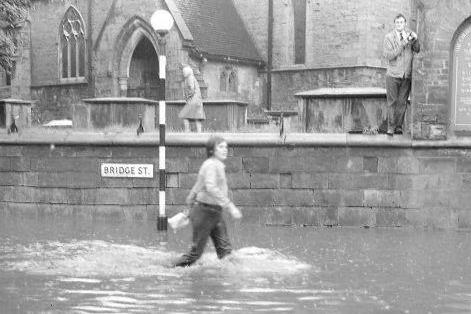 Walkers had to wade through deep water on Bridge Street to get anywhere in 1973.