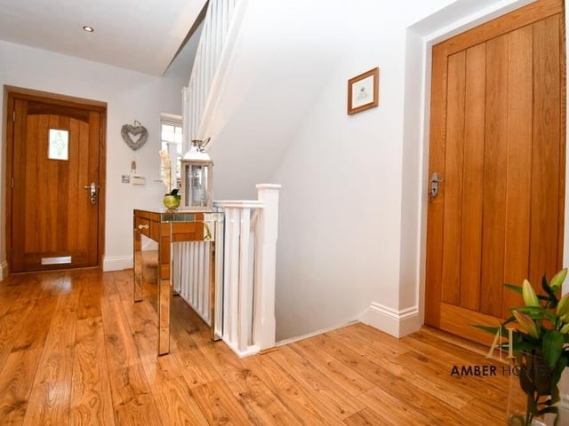 Up the stairs from the lower floor, you are greeted by this grand entrance hall. It sets the tone for the elegance and comfort that awaits on the rest of the ground floor.
