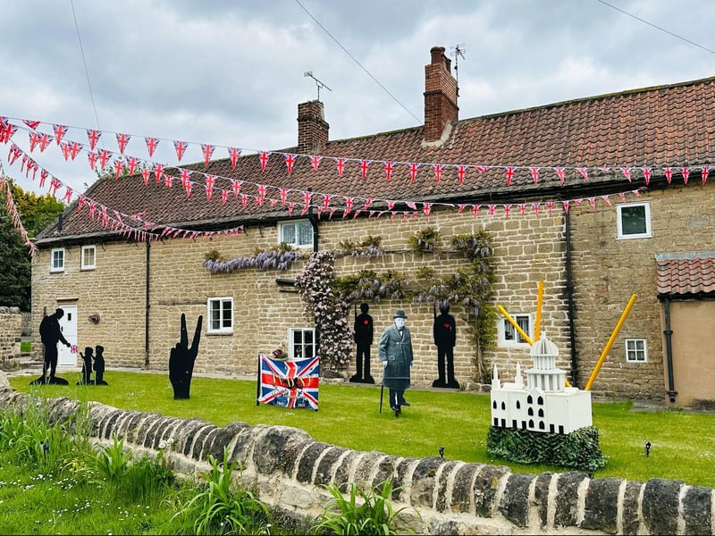 The display embodies the essence of the historic event, showcasing Prime Minister Winston Churchill along with his "V for Victory" symbol.