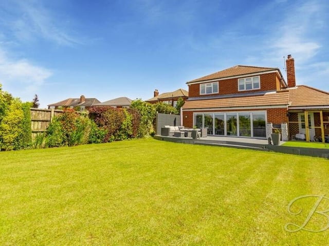 Let's conclude our gallery with a handful of exterior shots, beginning in the magnificent back garden, which features an extensive lawn, surrounded by gorgeous, mature shrubs and trees.