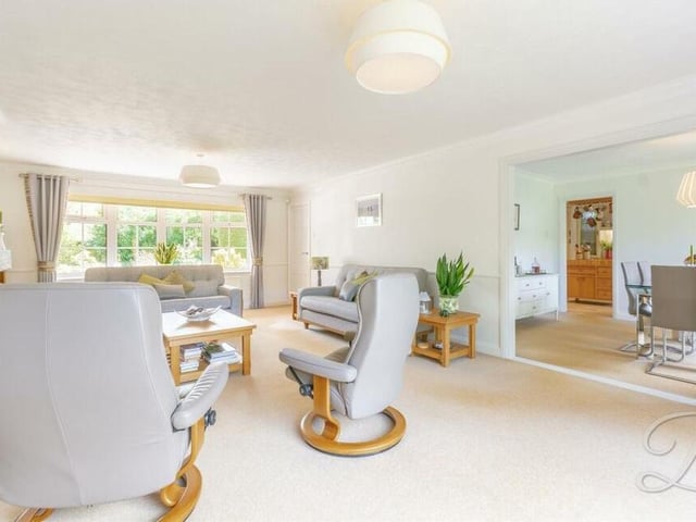 A second shot of the bright lounge, which also has a large window facing the front of the house. As part of its open-plan layout, it leads seamlessly into the dining room.