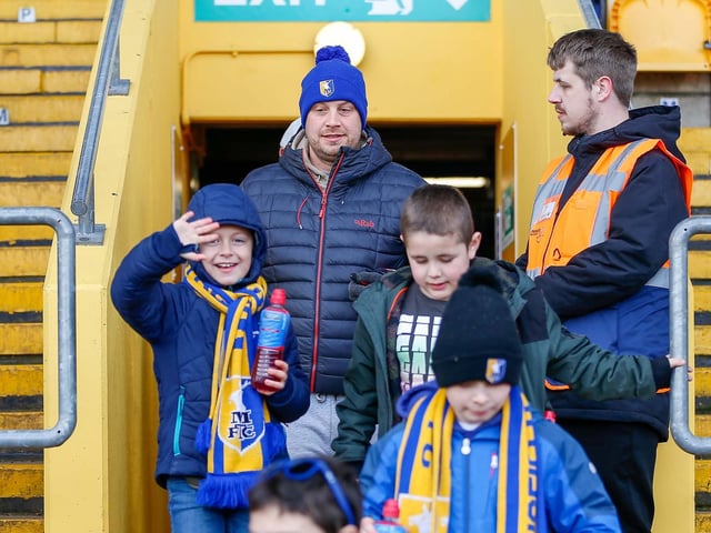 Mansfield Town fans watch the match against Northampton Town.