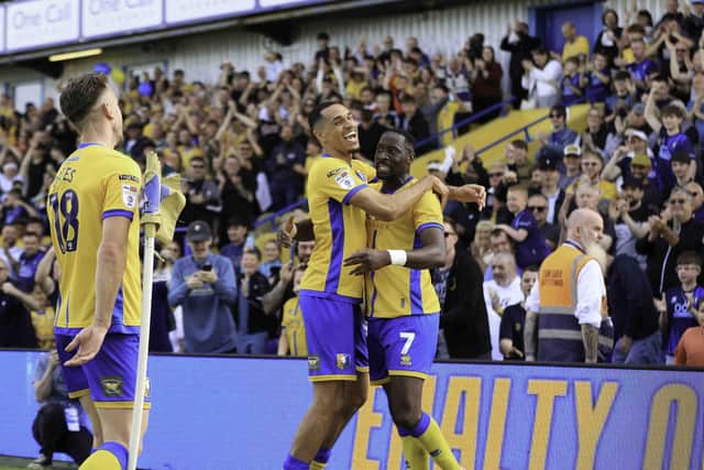 Lucas Akins celebrates his first half goal against Cardiff City with Jon Russell. Both players have recently agreed new deals with Mansfield Town.