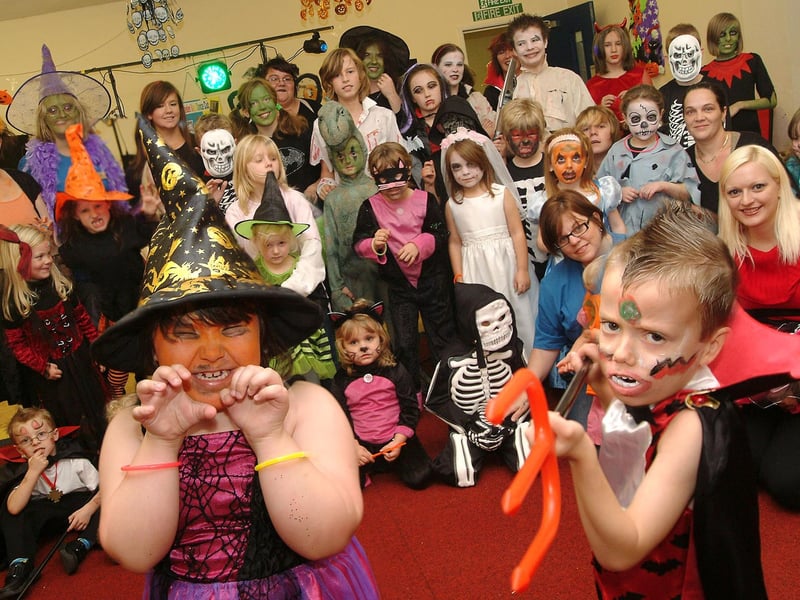 Youngsters and their carers get all spooky in their Halloween costumes during a daytime Myths and Magic disco for the Elkesley Raod Play Scheme in Meden Vale, 2009.