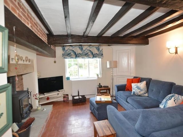 Another beamed ceiling in the cosy snug, which also benefits from a feature fireplace, log burner with stone hearth, brick inset and fireside shelving. Other assets are a quarry tiled floor, a Yorkshire casement window, wall lights and corner cupboards.