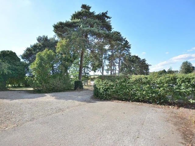 At the end of the long driveway, there is a turning space for vehicles.
