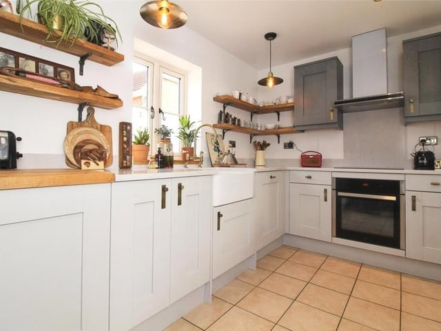 The kitchen at the Sutton barn conversion is impressive, as you can see. It features an array of light grey and medium grey units with brushed brass handles.