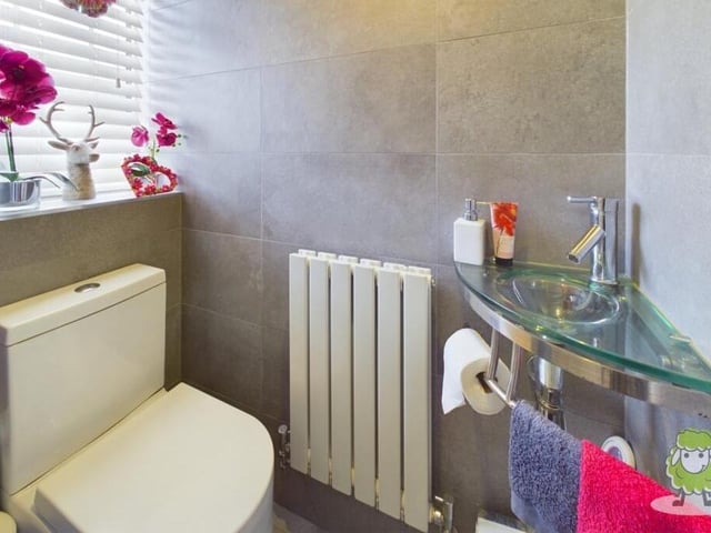 Adding to the practicality of the ground floor is this convenient toilet with low-flush WC and a very smart and quirky wash hand basin.