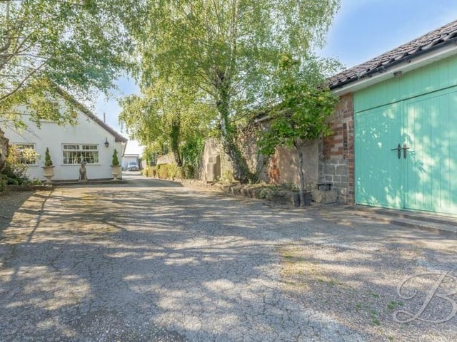 A handy barn, which can be used to your advantage, sits off a large driveway that provides ample space for off-street parking.