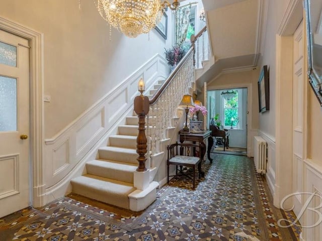 As we prepare to check out the first floor, let's pass through the attractive entrance hallway to ascend the staircase.