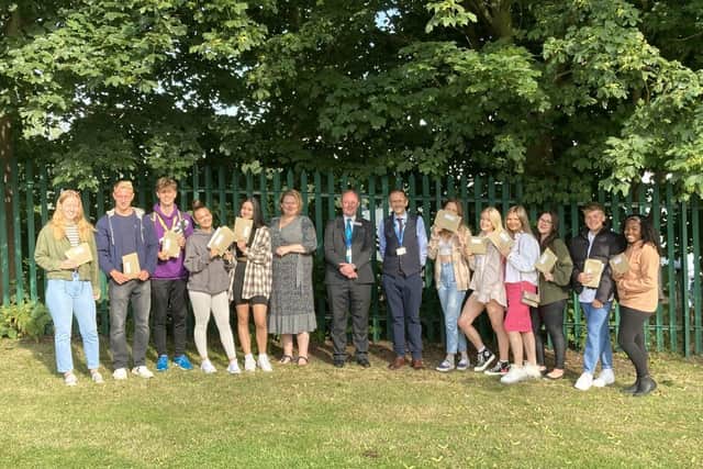 CEO of The Evolve Trust, Claire-Marie Cuthbert, Principal of The Brunts Academy, Carl Atkin, and Martin Fiddimore, Assistant Headteacher of Brunts 6th Form, celebrating with students.