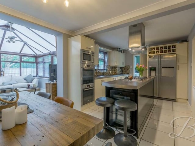 At the heart of the home is a spectacular open-plan kitchen and dining room that also flows seamlessly into a conservatory.